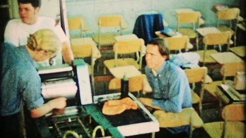 Students in print shop class run a printing press 1950s vintage home movie 4670 Stock-Footage 86582010