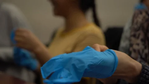 Students put on gloves in biology class Stock Footage 107321430