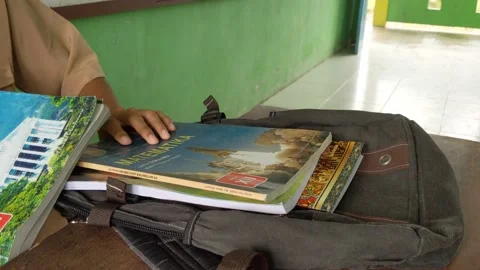Students put their textbooks into the bag Stock Footage 203195578