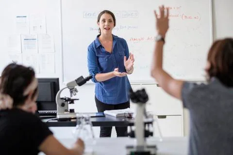 Students questioning professor in classroom Stock Photos