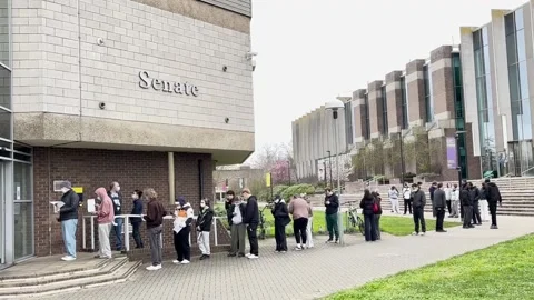 Students queue for antibiotics at the University of Kent after meningitis outbr Stock Footage 330941492