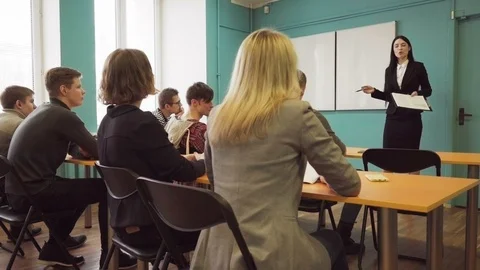 Students raise hands after the teacher's question during lecture Stock Footage 86516104