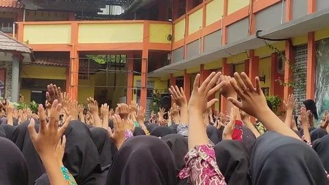 Students raise their hands in the school yard Stock Footage 256865614