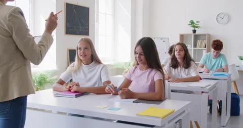 Students raise their hands, signaling their desire to answer teacher questions Stock Footage 331904605