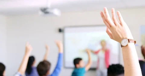 Students raising their hands in classroom Stock Footage 74230205