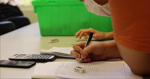 Students reading and writing down data in form after engineering tests in lab Stock Footage 162966064