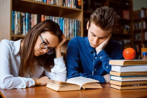 Students reading book, preparing for classes Stock Photos