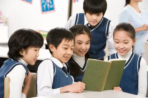 Students reading a book together Stock Photos