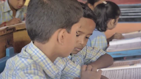 Students reading a lesson from the book in their class. Stock Footage 104986687