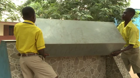 STUDENTS REMOVING SECURITY COVER FROM WATER FAUCETS Stock Footage 60115642