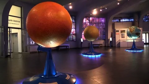 Students run to class in hall with copy model of solar system planet Stock Footage 83498853