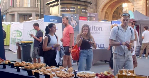 Students sampling pastries and drinks at outdoor graduation event inPr 動画素材 347959215