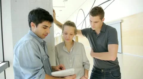 Students in school hallway using electronic tablet Stock Footage 14826936