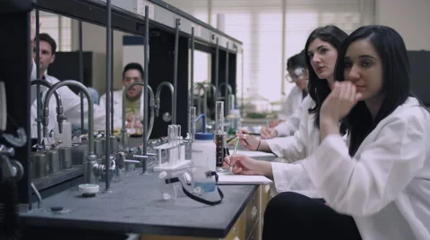 Students in a science lab listen to their professor and raise their hands Stock Footage 55274542