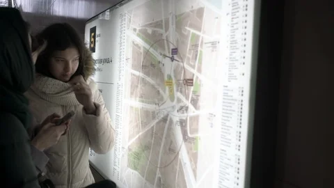 Students search for right destination looking at city map Stock Footage 123398656