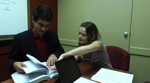 Students searching a text book Stock Footage 52046658