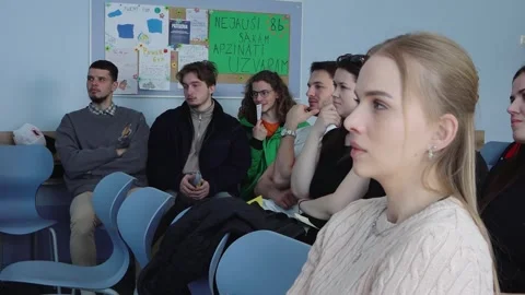 Students seated in a classroom during a group lesson or seminar, listening 스톡 동영상 335175039