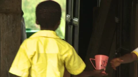 STUDENTS SHARE A CUP OF WATER Stock Footage 60626160