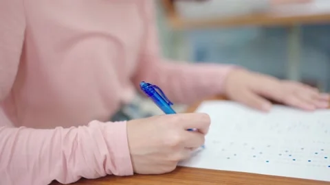 Students sit for exams at the desks in the classroom at the university. Stock Footage 147957047