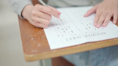 Students sit for exams at the desks in the classroom at the university. Stock Footage 147957052