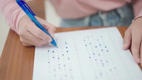 Students sit for exams at the desks in the classroom at the university. Stock Footage 147957054