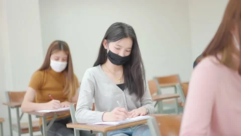 Students sit for exams at the desks in the classroom at the university. Stock Footage 147957081