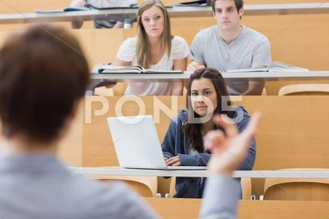 Students sitting listening to the teacher Stock Photos