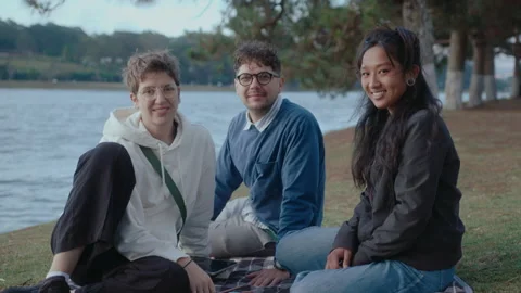 Students Sitting in the Park and Smiling on Camera Video stock 237059111