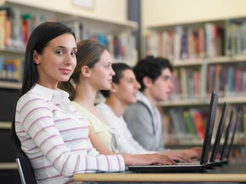 Students Sitting In Row Using Laptops In Library 写真素材