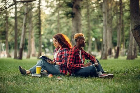 Students sitting with their backs to each other Stock Photos