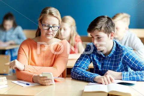 Students with smartphone texting at school Stock Photos