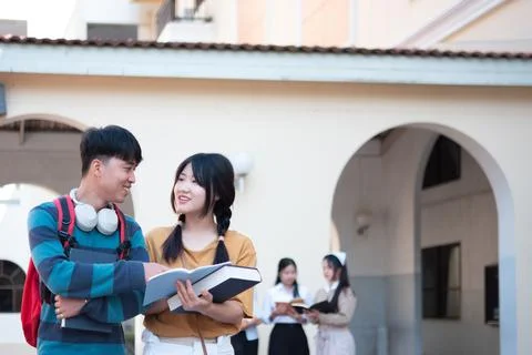 Students smiling while studying together on campus Stock Photos