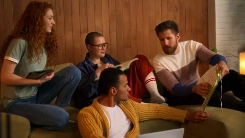 Students on sofa use laptop, tablet and notebooks Stock Footage 267827044