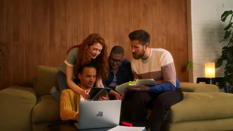 Students on sofa use laptop, tablet and notebooks Stock Footage 267829300