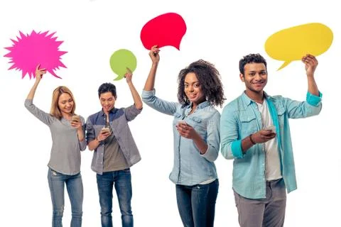 Students with speech bubbles and gadgets Foto stock