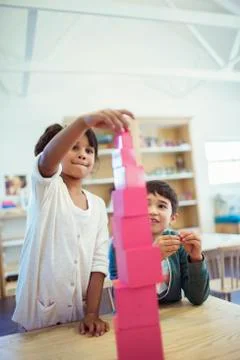 Students stacking blocks in classroom Stock Photos