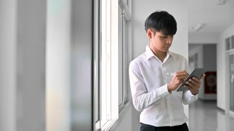 Students standing on the balcony Write down ideas	 Stock Footage 224354993