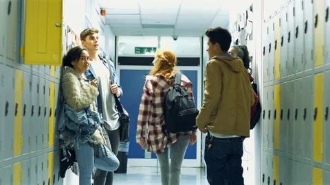 Students standing by lockers Stock Footage