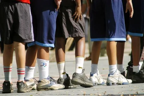 Students standing in queue during basket ball practice session in school i... Stock Photos