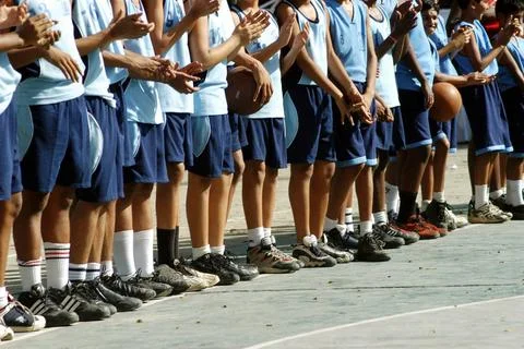 Students standing in queue during basket ball practice session in school i... Stock Photos