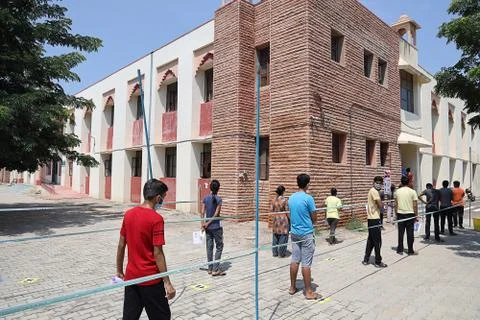 Students standing in queue while maintain social distancing before enter Stock Photos