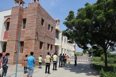 Students standing in queue while maintain social distancing before enter Stock Photos
