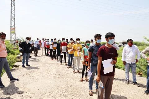 Students standing in queue while maintain social distancing Stock Photos