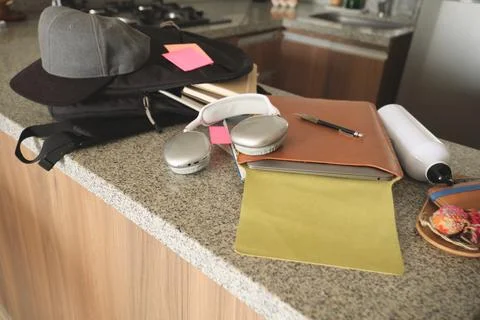 Student's study essentials on a kitchen counter, ready for learning Фото