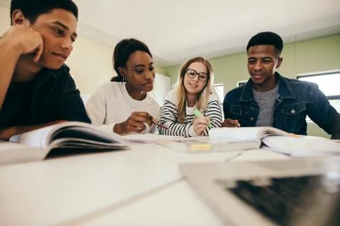 Students studying with books in classroom Stock Photos