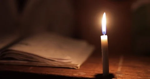Students Studying in a class by candlelight and kerosene lantern in Mbale . Stock Footage 119153442