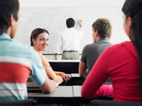 Students Studying In Classroom With Professor Stock Photos
