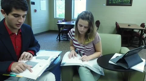 Students studying in library chairs Stock Footage 52046657