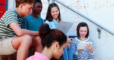 Students studying math together on school steps, using tablet and notebook Illustrazione stock