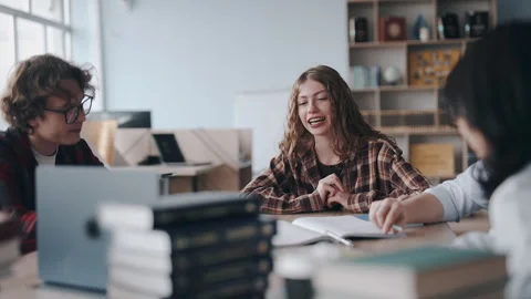 Students studying together in a college library Stock Footage 331663412